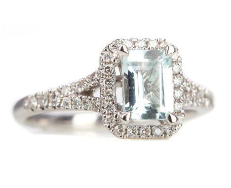 AQUAMARINE AND DIAMOND RING,the step cut aquamarine within a halo of round brilliant cut diamonds, on diamonds shoulders tota