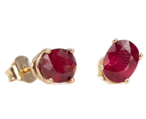 PAIR OF TREATED RUBY EARRINGS,the fissure filled oval rubies set to nine carat gold mounts