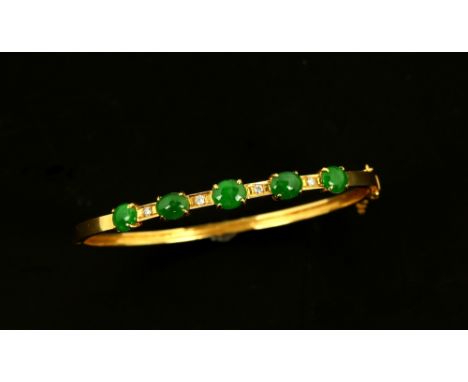 Vintage jade and diamond bangle, set with five oval  cut jade cabochons alternately set with four round brilliant cut diamond
