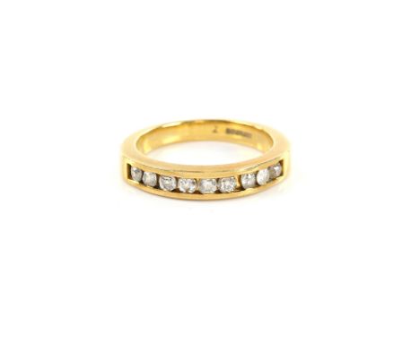 Half eternity ring, channel set with brilliant cut diamonds, in 18 ct gold mount, ring size M.   CONDITION Good condition, di