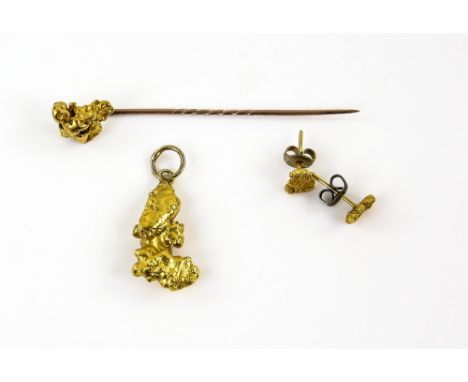 A mixed group of items, including a nugget pendant, with similar earrings and a stick pin, testing as 18 ct or higher, three 