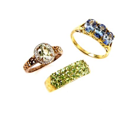 Three gem set rings, zultanite diaspore, and diamond cluster ring, ring size M, tanzanite and zircon ring, size N and green g