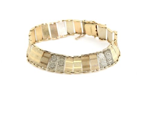 Art Deco period panel bracelet, the articulated links with engine turned  and flower head decoration, stamped on clasp, 9 ct 