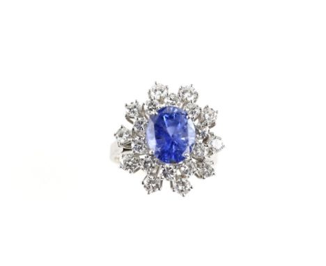 Sapphire and diamond ring, set with central oval sapphire of good colour, estimated at 4.78 carats, with twenty satellite dia