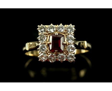 Diamond and ruby set dress ring, the central  step ruby within  a border of brilliant cut diamonds, diamond weight estimated 