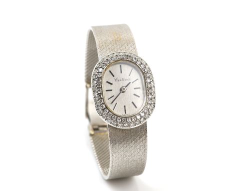 Certina a ladies white gold dress watch, signed dial with baton hour markers, oval case with a diamond set bezel, the case ba