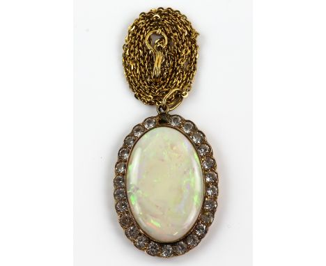 An opal and white sapphire  pendant, in unmarked yellow metal mount  with similar chain, both testing as 9ct opal 2.8 x 1.9 c