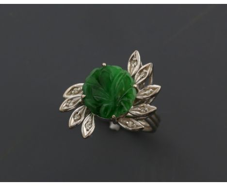 Jade and diamond ring, round floral carved jade panel, surrounded by nine marquise petals set with Swiss cut diamonds, mount 