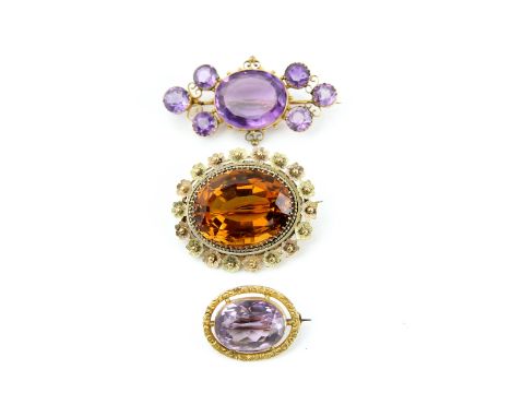 Four antique brooches, one oval cut citrine, 30 x 22mm, surrounded by beaded and floral border, stamped 15 ct, another seven 