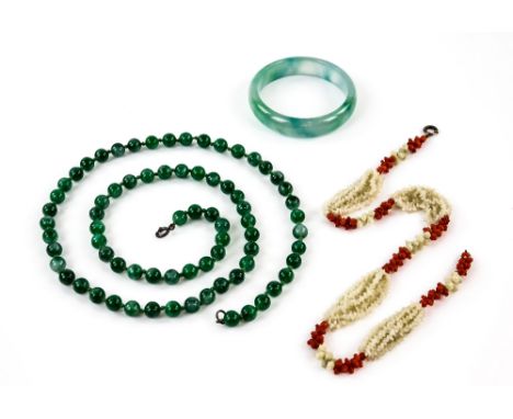 Round Jade bangle, inside diameter 5.5cm, in addition to a white and red multi strand coral necklace, 42cm and long green qua