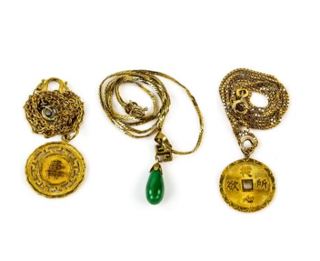 Three Chinese pendants, including two disk shaped pendants with character details, both with chains, testing as 18 ct or high