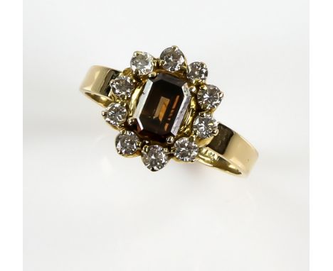 Cognac fancy coloured diamond dress ring,  the central emerald cut stone within a border of white diamonds, fancy diamond wei