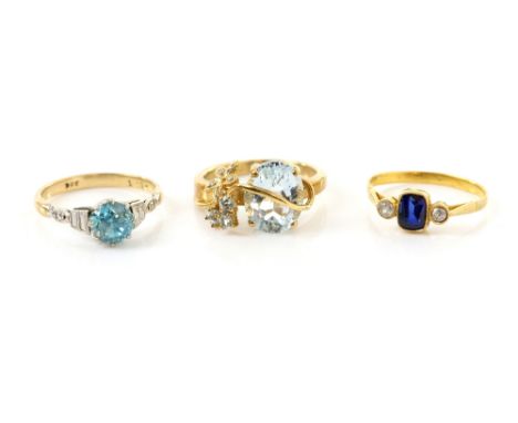 Three gold dress rings, an aquamarine and diamond set ring, another set with blue zircon, both 9 ct and a synthetic blue and 