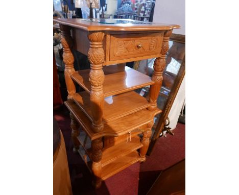 A pair of Indonesian carved teak side tables, with bevelled glass inserts over frieze drawer and undertier shelf, H.58cm W.60