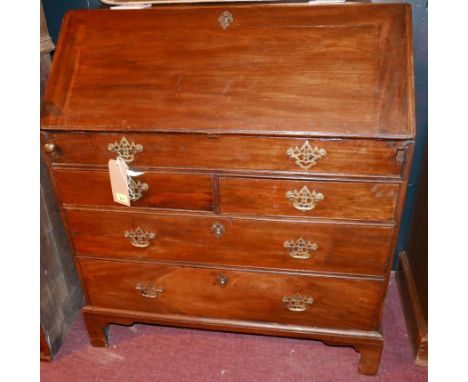 A Georgian mahogany bureau, the fall front enclosing fitted interior over dummy drawer and two short and two long drawers rai
