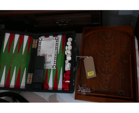 A teak bagatelle board, together with a travelling backgammon set 