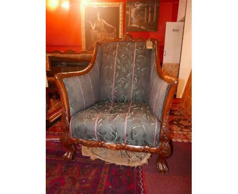 A pair of Chippendale style mahogany armchairs, raised on ball and claw feet 