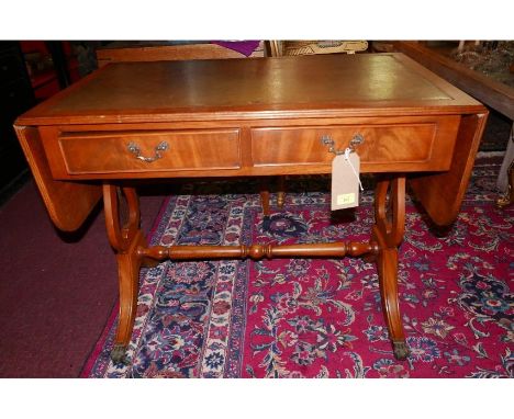 A Georgian style walnut sofa table, with gilt tooled green leather top over twin drawers opposing dummy drawers, raised on st