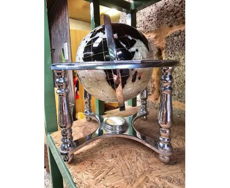 SMALL STONE SET GLOBE IN A WHITE METAL STAND