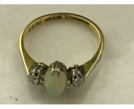 An 18ct and platinum diamond and cabochon opal ring