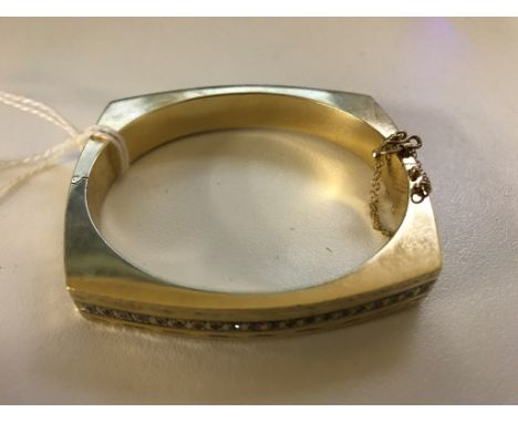 A 14k abstract diamond set bangle