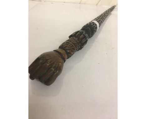 A novelty walking stick topped with a clenched fist