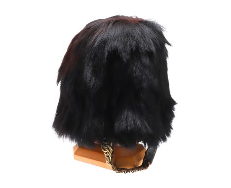 An Other Ranks Bearskin Cap with traditional wicker frame interior, leather lining and leather backed brass chin scale. On a 