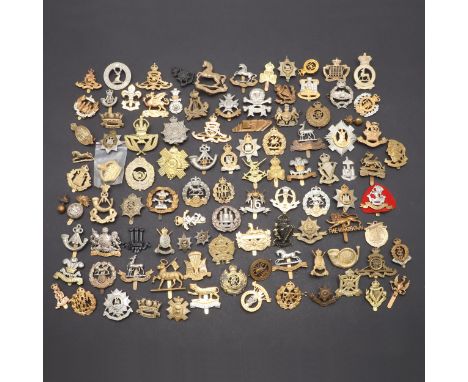 A collection of approximately 100 cap badges to include examples for The Warwickshire Regiment, King's Own Light Infantry, Ho