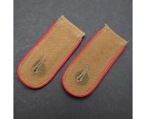 A pair of Army Afrikakorps Artillery Man's shoulder straps. Sand cloured material with fieldgrey undersides and bright red pi