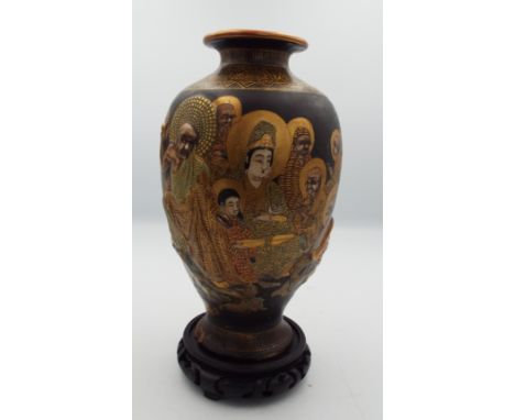 A Japanese Satsuma vase, Meiji period, with the 'Thousand Faces' design and raised immortals above a calligraphy panel, heigh