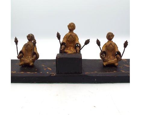 A Chinese gilt bronze automaton, Qing Dynasty, with three seated figures on a rectangular wooden plinth, height 11.5cm, width