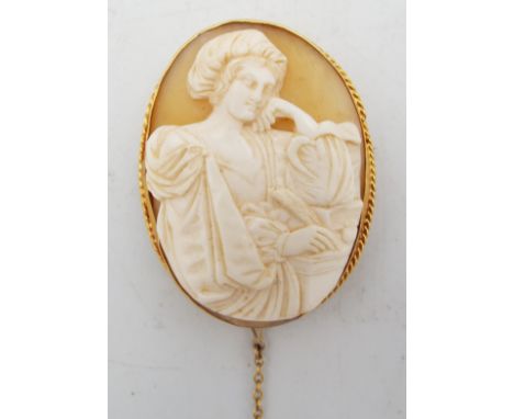 A 19th century cameo brooch with yellow metal mount depicting a turbaned lady with quill in hand, test as gold, 4.5cm x 3.1cm
