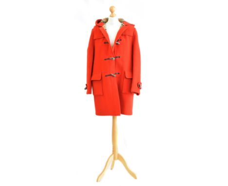 A Burberry wool duffle coat, the red wool three quarter length coat with horn hook fastenings and maker's nova check interior