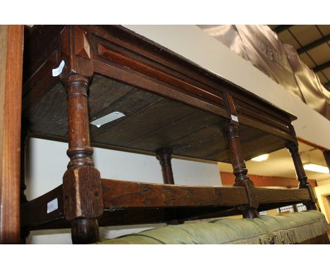 17th Century style oak bench with hinged top, the rectangular top raised on six turned legs, united by square stretchers, 115