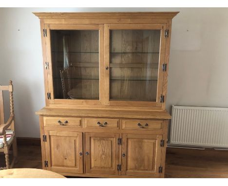 Light oak dresser, the cabinet with two glazed doors, opening to reveal two glass shelves, the base with three frieze drawers