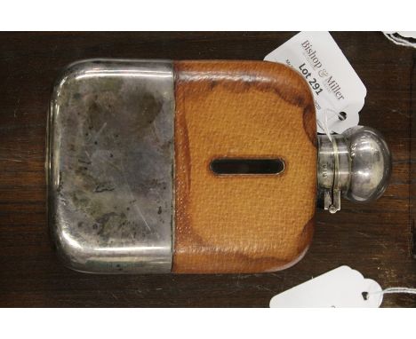 Silver plated hip flask, the bayonet cap above a brown leather body and detachable plated tot cup