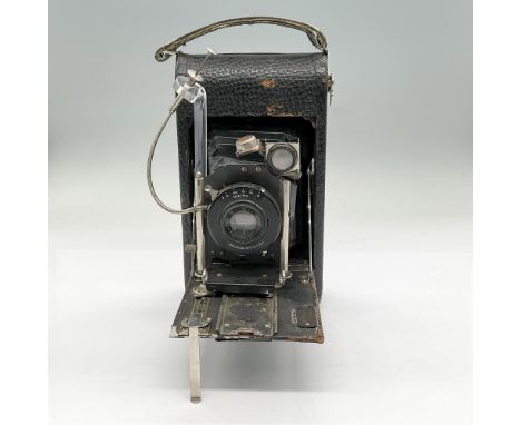 R.F. Seneca roll film camera with bellows, flip down front support and Wollensak lens. With the camera open, measures 7"L x 4