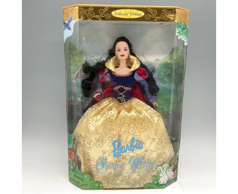 New in Box. Dressed as story book character in brocade gown with flowing black hair, holding an apple. This item has its orig