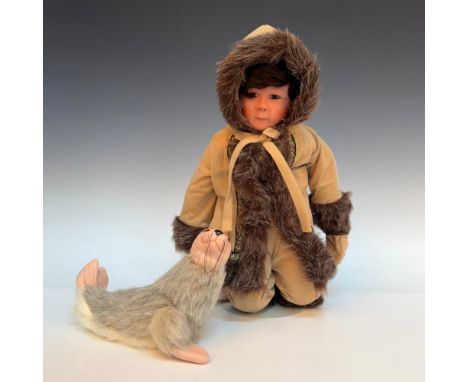 New in original packaging. This porcelain Eskimo boy is wearing traditional clothing of the Northern Hemisphere, suede with f