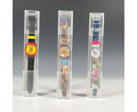 Three Swatch watches in quartz movement, all in original hard plastic cases with folded informational sheets including Poeta 