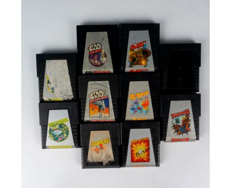 An assortment of vintage video games of various titles. Titles includes Q*bert, Star Wars: Jedi Arena, Star Wars: The Empire 