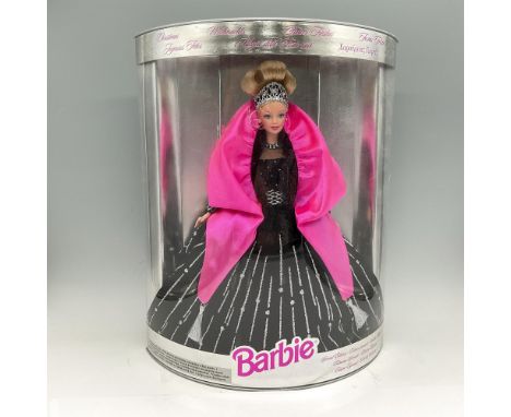 New in Box. Dressed in flowing black velvet gown with silver accents. Her stylish hairstyle is accented with banded rhineston