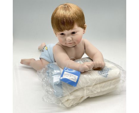 New in original packaging. Adorable porcelain red haired baby caught in a crawl position looks out with brown eyes. Wearing h