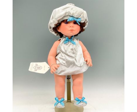 This charming vinyl doll dressed as a Kiss with her silver hat, dress and booties with blue bows looks at you with puckered l