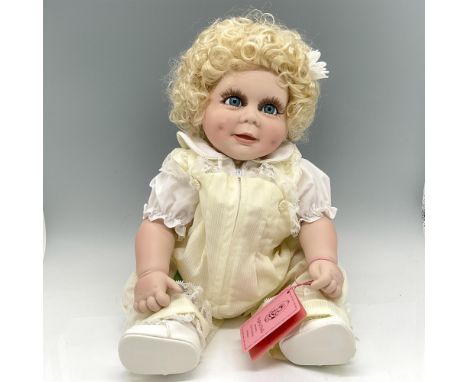 Created with dimpled cheeks, blonde curly hair with daisy, bright blue eyes wearing a yellow and white jumper. Edition 1723. 