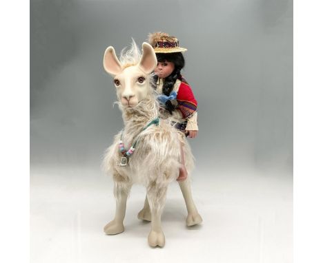 Traditional dress on porcelain doll representing South America, sitting atop her Lama. Both meticulously created and colored 