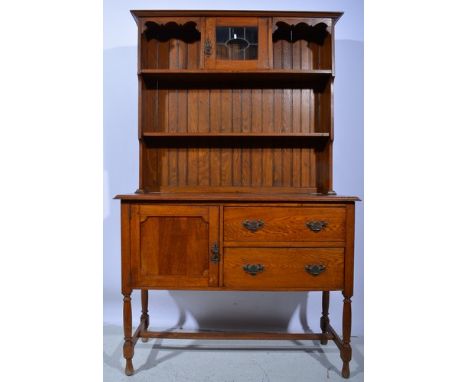 Oak dresser, two shelf rack incorporating a glazed door with leaded panels, cupboard and two drawers under, width 122cm.