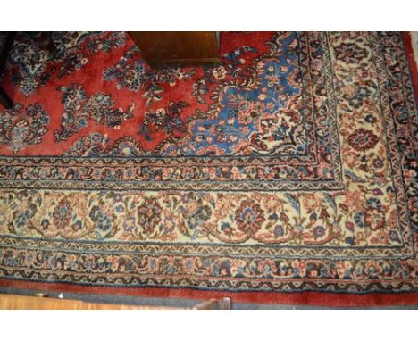 Tabriz pattern carpet, central medallion, red field, multi bordered, 300cm x 150cm.