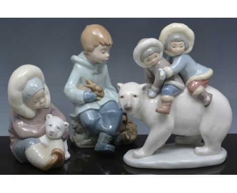 Lladro group of two Inuit children, on a Polar bear, 18cm, another Lladro figure of an Inuit child with a bear and a Nao figu