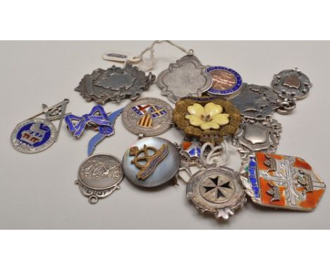 Collection of silver and other fobs, some yellow metal faced, silver and enamel armorial badge etc.